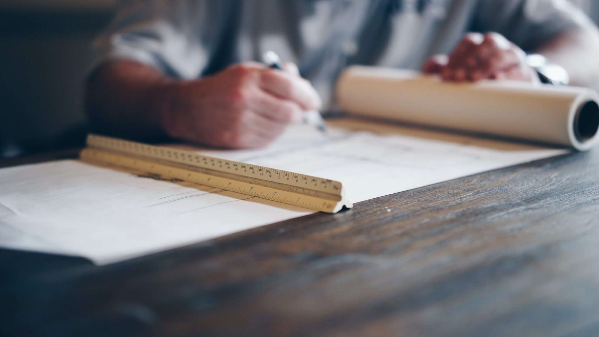 Architect Drawing on a Board